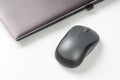 Computer wireless mouse next to a laptop on a white table close-up. electronic personal industry Royalty Free Stock Photo