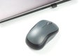 Computer wireless mouse next to a laptop on a white table close-up. electronic personal industry Royalty Free Stock Photo