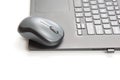 Computer wireless mouse next to a laptop on a white table close-up. electronic personal industry Royalty Free Stock Photo