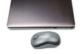 Computer wireless mouse next to a laptop on a white table close-up. electronic personal industry Royalty Free Stock Photo