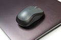 Computer wireless mouse next to a laptop on a white table close-up. electronic personal industry Royalty Free Stock Photo