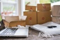 computer at workplace of start up, small business owner, freelance, entrepreneur, SME seller. cardboard parcel box of product for Royalty Free Stock Photo