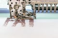 Computerized embroidery machines. sewing machine on blurred background. textile workshop. closeup