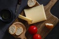 Comte french cheese on dark background. Mediterranean food concept