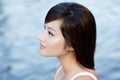 Comtemplative Chinese attractive girl by waters
