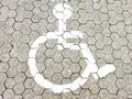 White Disabled parking sign on con block at parking area Royalty Free Stock Photo