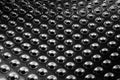 Concave metal surface background with holes