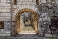 A concealed ascent into Brescia Castle, the northern staircase beckons through historic arches from Strada del Soccorso