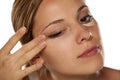 Concealer under her eyes Royalty Free Stock Photo