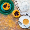 Conceived with the morning coffee and cakes Pasteis de nata, typical pastry from Portugal on natural marble surface. Royalty Free Stock Photo
