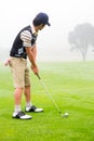 Concentrate golfer lining up his shot Royalty Free Stock Photo