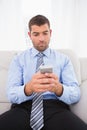 Concentrate man using his phone at home Royalty Free Stock Photo