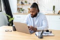 concentrated African American freelancer using laptop computer working from home Remote work Royalty Free Stock Photo