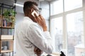 Concentrated african student talking by his phone. Royalty Free Stock Photo