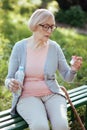 Concentrated aging woman holding bottle with pills outdoors Royalty Free Stock Photo