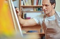 Concentrated artist painting picture on a canvas Royalty Free Stock Photo