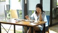 Concentrated asian businesswoman reading a textbook