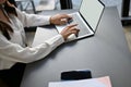 Concentrated Asian businesswoman using laptop, typing in notebook keyboard, working in office Royalty Free Stock Photo