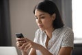 Concentrated asian japanese business woman texting message in cellphone. Royalty Free Stock Photo