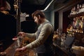 Bartender decorating pink cocktail with rose petal using tweezers Royalty Free Stock Photo