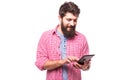 Concentrated bearded hipster man with digital tablet