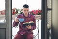 Concentrated bearded man reading books and drinking coffee or tea Royalty Free Stock Photo