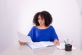 Concentrated beautiful young woman reading work material