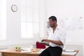 Concentrated black businessman in casual office, work with laptop