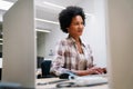 Concentrated black businesswoman employee worker analyzing online sales statistics data on computer Royalty Free Stock Photo