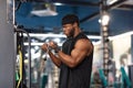 Concentrated black sportsman training muscles on block exerciser in gym