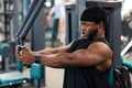 Concentrated black sportsman training muscles on block exerciser in gym Royalty Free Stock Photo