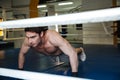 Concentrated Boxer doing push ups in gym