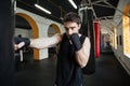Concentrated boxer doing training with punchbag