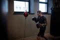 Concentrated boxer honing skills on double-end punching bag Royalty Free Stock Photo