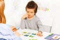 Concentrated boy plays developing game at table Royalty Free Stock Photo