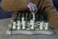 Concentrated boy plays with a green and white marble chess
