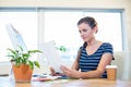 Concentrated brunette looking at photographs Royalty Free Stock Photo