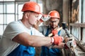 Concentrated builders remove old plaster from a brick wall Royalty Free Stock Photo