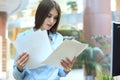 Concentrated business lady comparing documents at office. Royalty Free Stock Photo