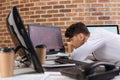 young businessman sitting near computers, smartphone Royalty Free Stock Photo