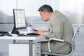 Concentrated Businessman Using Computer At Desk