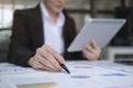 Concentrated businesswoman analyzing online statistics data on digital tablet, checking financial documents at office Royalty Free Stock Photo