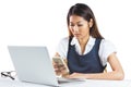 Concentrated businesswoman using smartphone and laptop Royalty Free Stock Photo