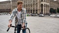 Concentrated caucasian man with bicycle look away Royalty Free Stock Photo