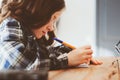 Concentrated child girl doing homework. Thoughtful school kid thinking and looking for an answer Royalty Free Stock Photo