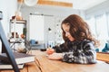 Concentrated child girl doing homework. Thoughtful school kid thinking and looking for an answer Royalty Free Stock Photo