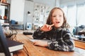 Concentrated child girl doing homework. Thoughtful school kid thinking and looking for an answer Royalty Free Stock Photo