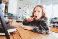 Concentrated child girl doing homework. Thoughtful school kid thinking and looking for an answer Royalty Free Stock Photo