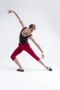 Concentrated Contemporary Ballet Dancer Flexible Athletic Man Posing in Red Tights in Ballanced Dance Pose With Hands Inclined In