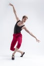 Portrait of Concentrated Contemporary Ballet Dancer Flexible Athletic Man Posing in Red Tights in Ballanced Dance Pose With Hands